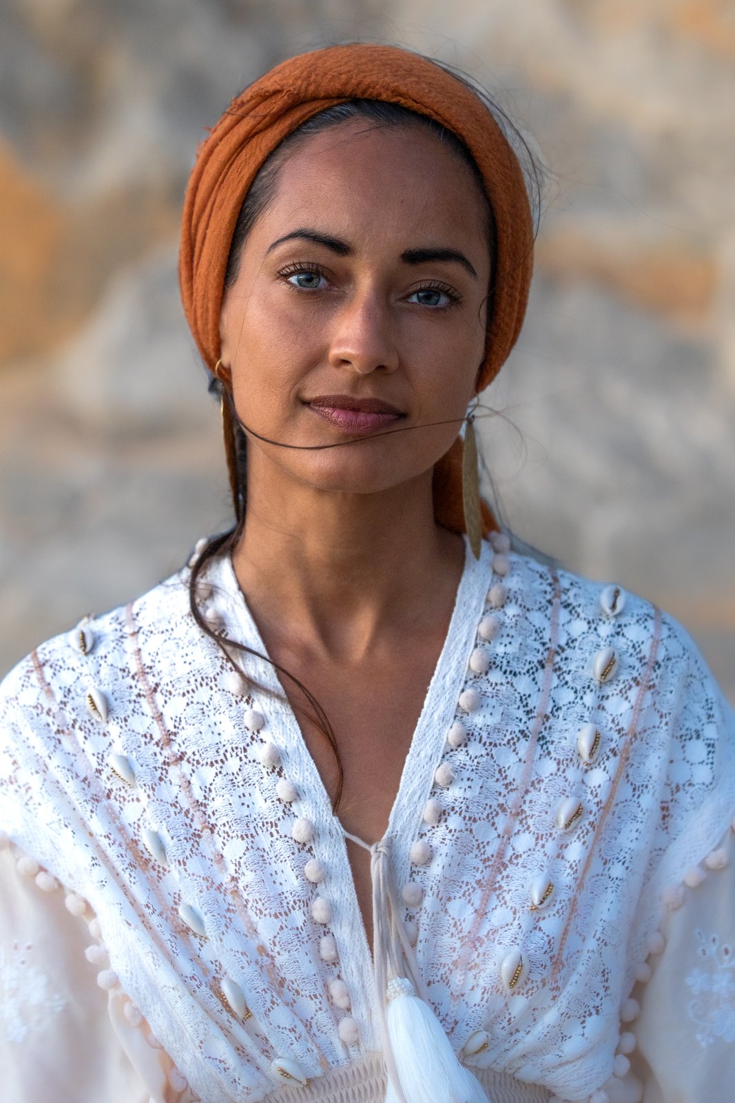 Portrait of a woman in a headscarf and white embroidered top