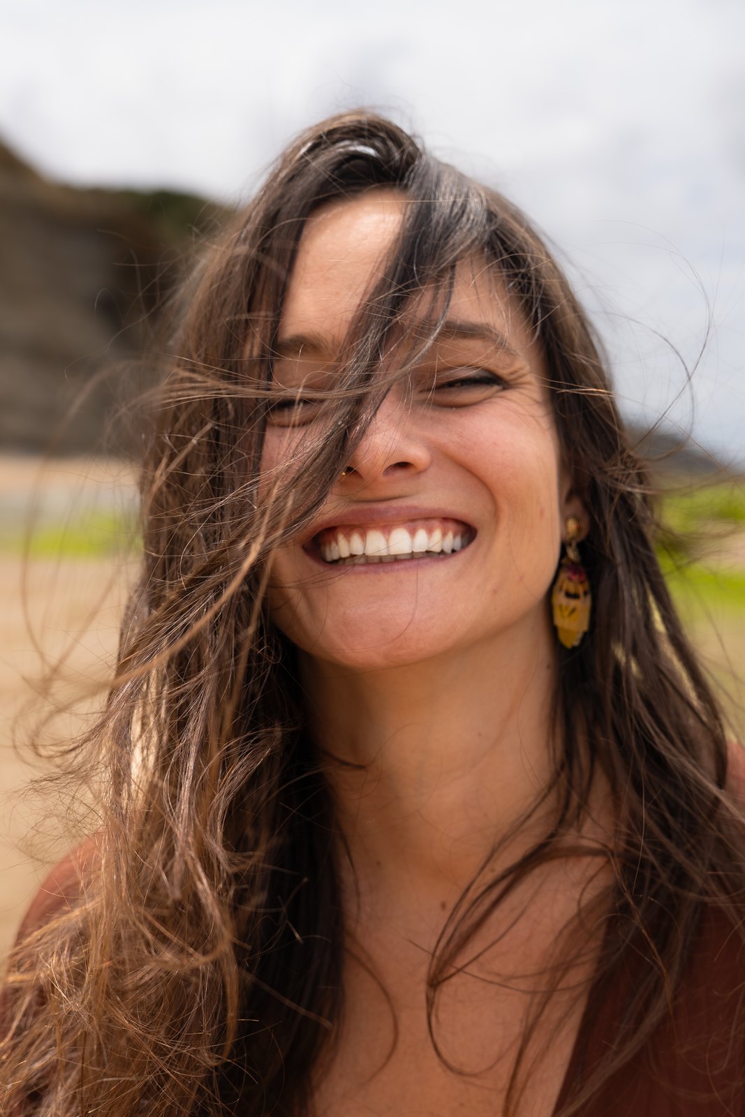 Woman laughing with windblown hair